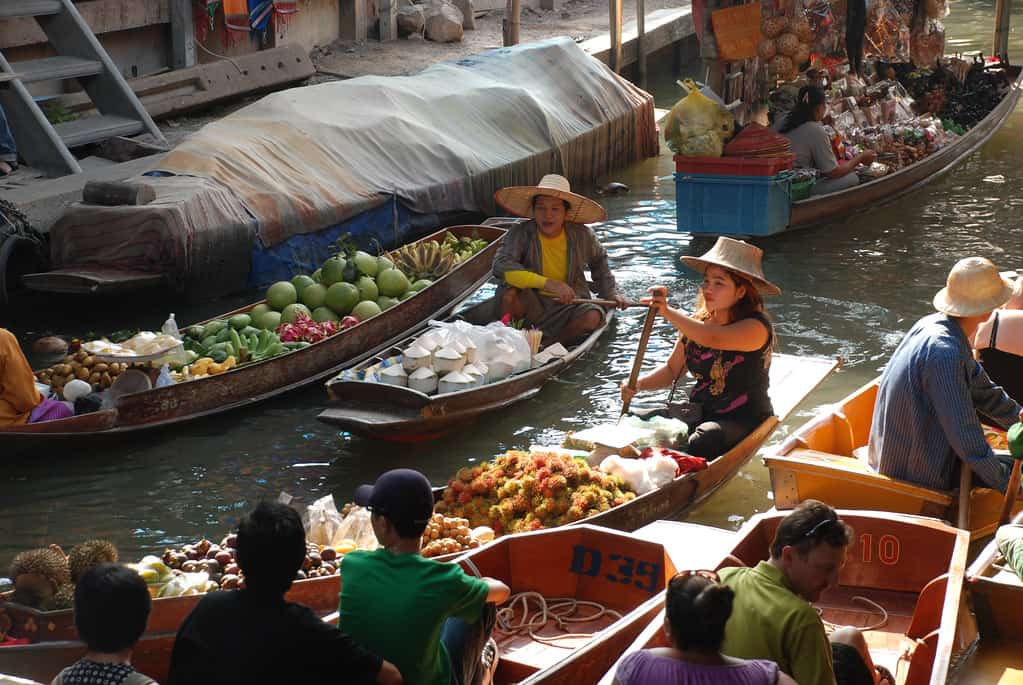 Damnoen Saduak floating market. Tourist will sit on the sampan and buy things from the sampan. it's worth a visit when you travel to bangkok. 