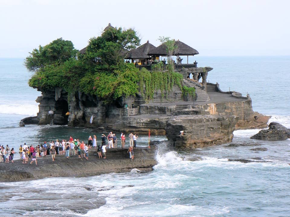 Tanah Lot Temple is built on the rock formation of the sea. It is also well known for its offshore setting and sunset backdrops. 